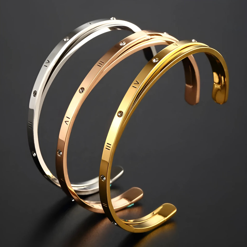 Open-ended stainless steel bracelet with electroplated finish and inlaid zircon stones.