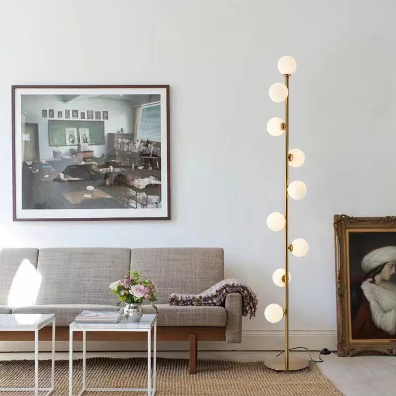 Minimalist modern floor lamp with wrought iron frame, glass elements, and marble base showing height and design details