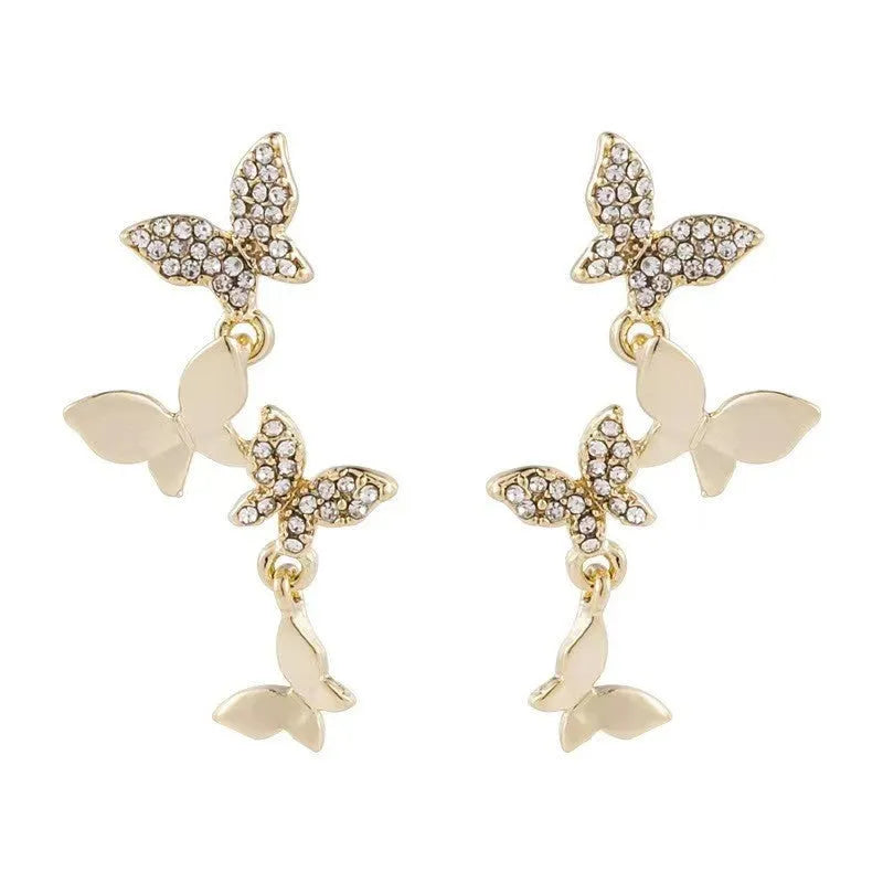 Women's gold-coloured copper butterfly earrings with four detailed designs in dangle drop style
