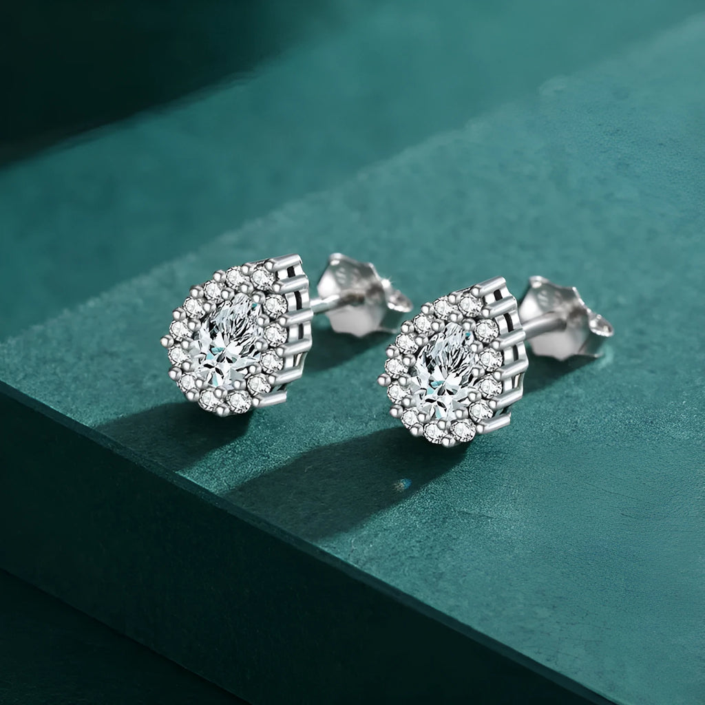A pair of women's sterling silver water drop ear studs with a diamond-cut shiny finish.
