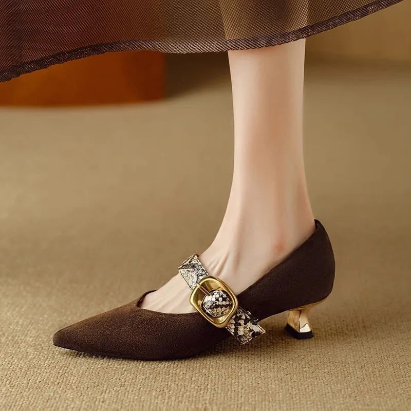 Black French pointed stiletto high heels for women with a buckle strap across the instep.