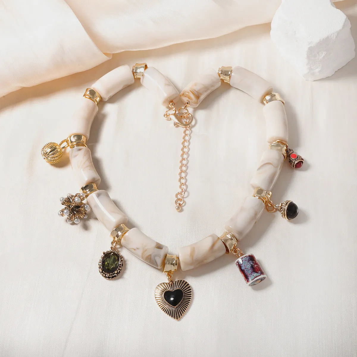Women's resin bamboo heart necklace with electroplated metallic accents
