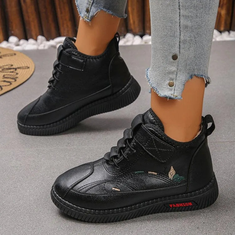 Women's black velvet house shoes with rubber soles and cotton lining, showing low tube design and hollow out decorative elements
