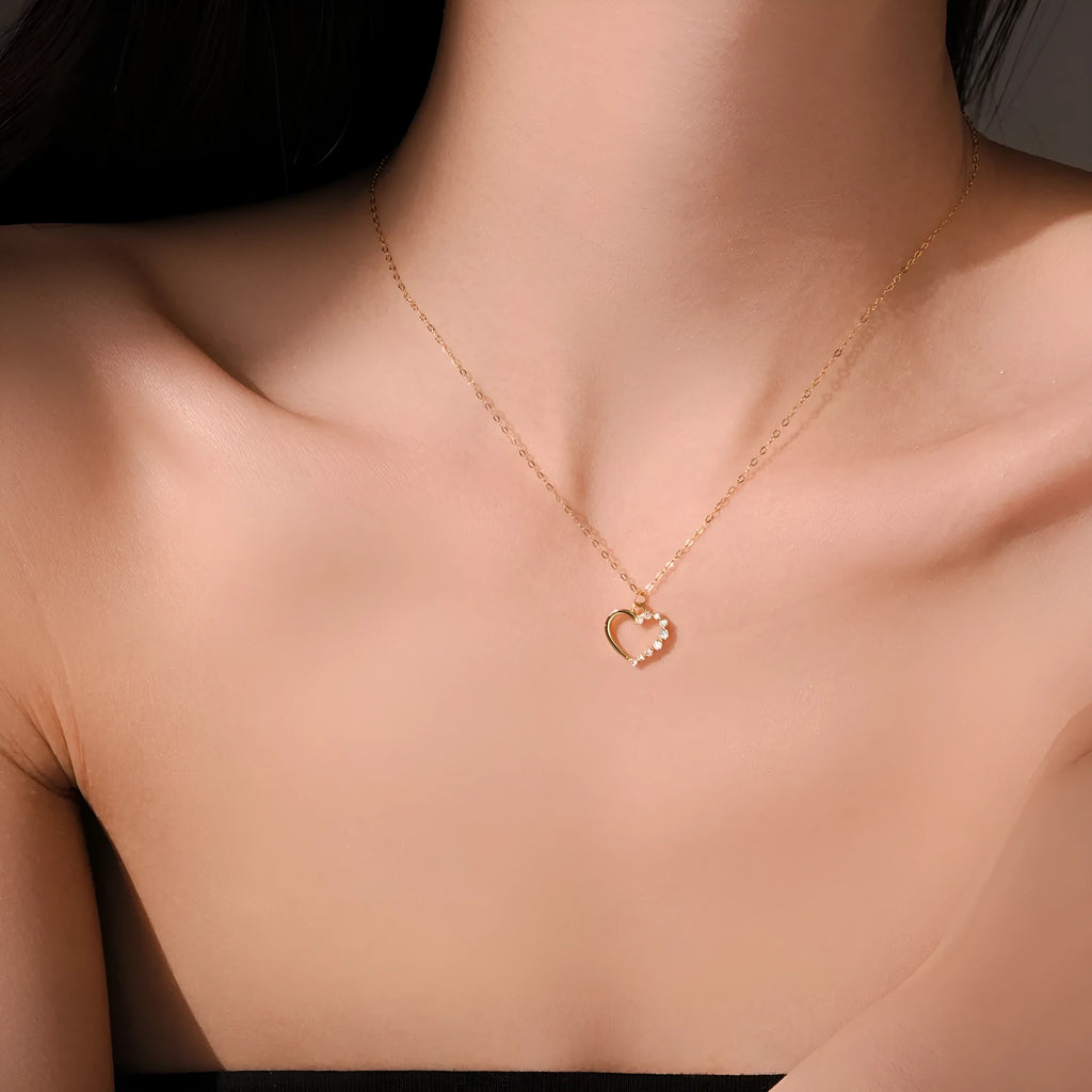 Sterling silver hollow heart necklace with circle elements, available in gold or platinum plating