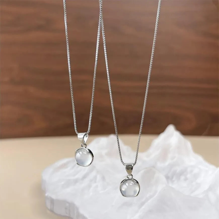 Women's oval pendant necklace with an eight-point star design on an adjustable box chain.