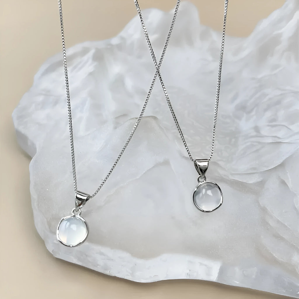 Women's oval pendant necklace with an eight-point star design on an adjustable box chain.