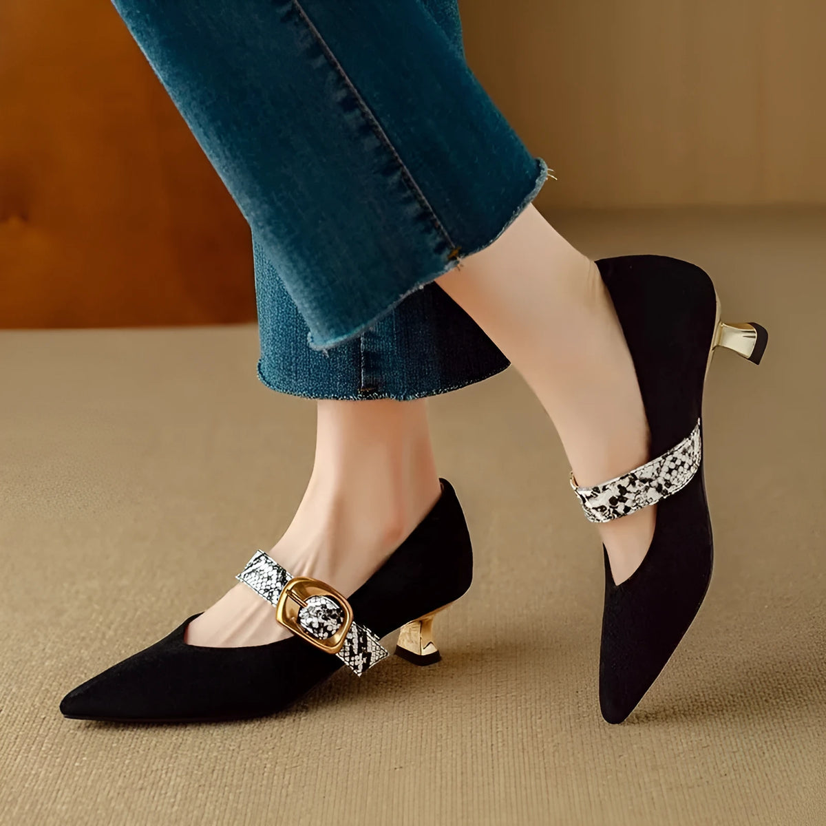 Black French pointed stiletto high heels for women with a buckle strap across the instep.