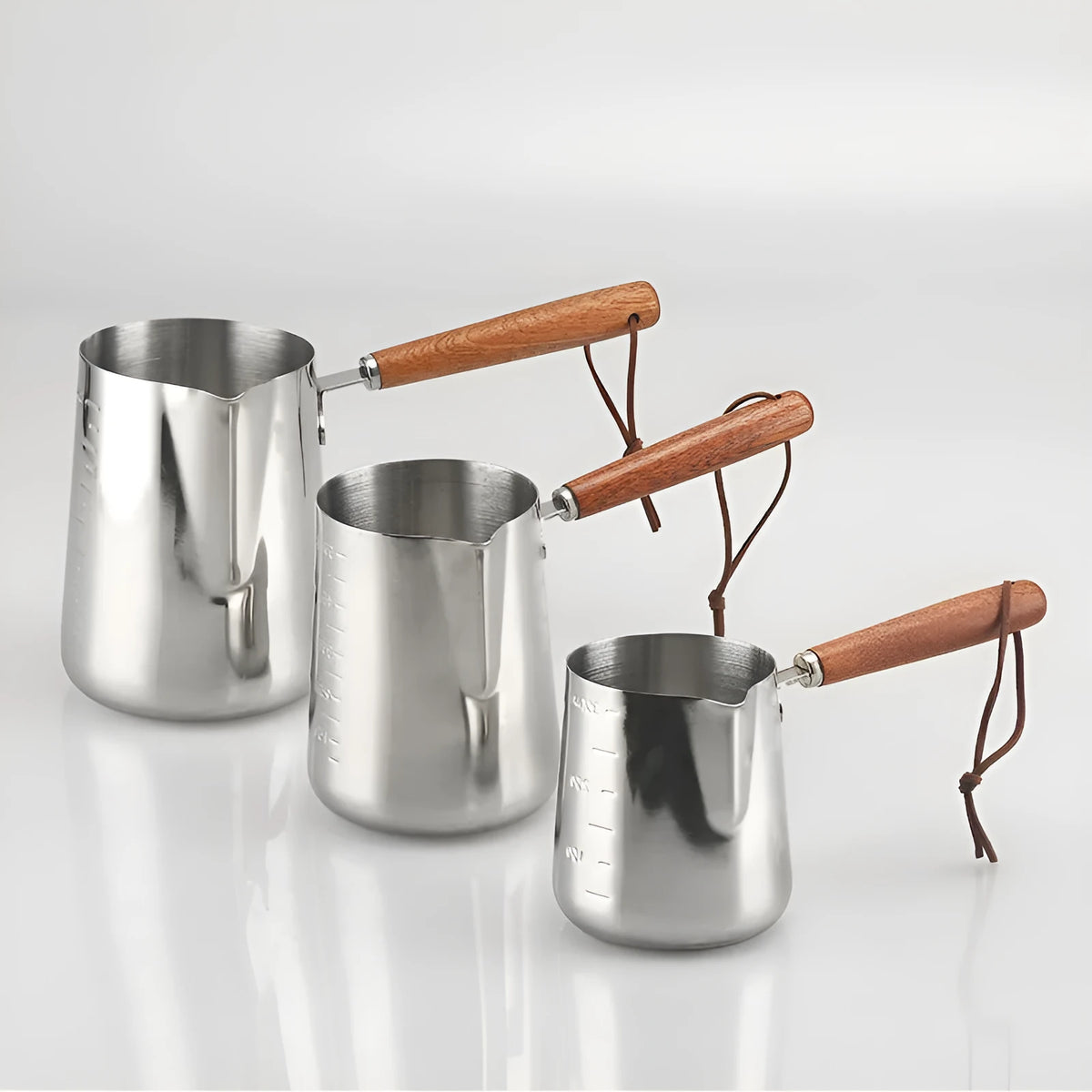 Stainless steel coffee cup with wooden handle and internal measuring scale.