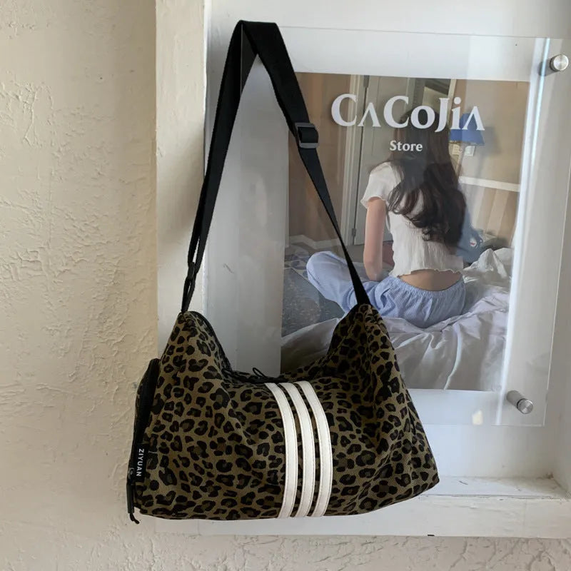 Leopard print sports style shoulder messenger bag with stitching detail and cross-body strap