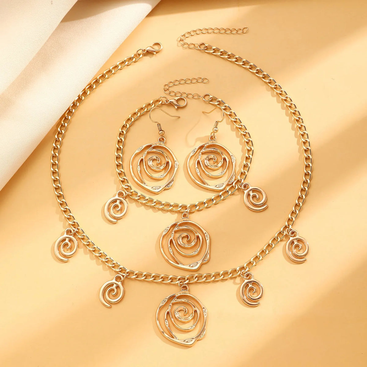 Spiral donut jewellery set with geometric circle designs including adjustable necklace, bracelet and ear hooks