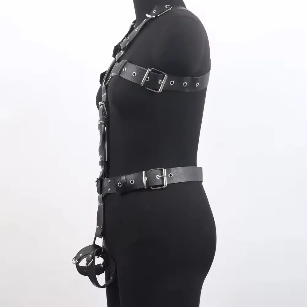 Black patent leather bondage body harness with thin straps and a pin buckle.