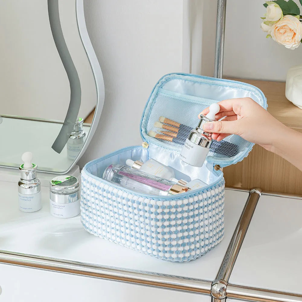 Four coordinating flannelette makeup bags in cube design with polyester construction