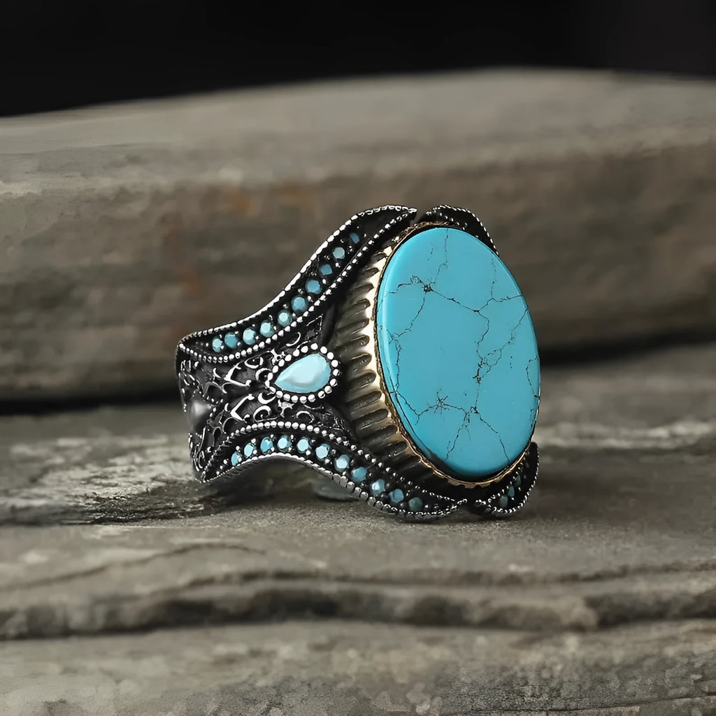Men's antique silver alloy ring with a simple round turquoise stone, shown on a finger.