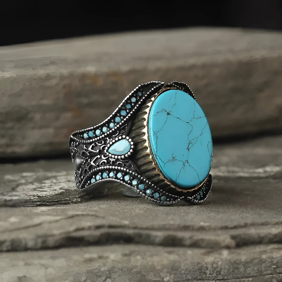Men's antique silver alloy ring with a simple round turquoise stone, shown on a finger.