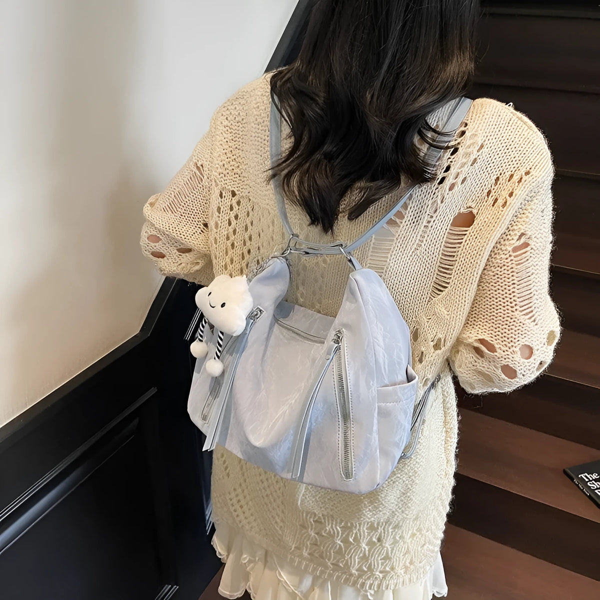 Soft black PU women's fashion backpack with a detachable silver pendant charm.