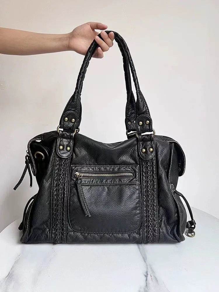 Women's French retro motorcycle messenger bag in soft PU leather with woven accents and internal compartments