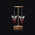 Silver coloured alloy bat-shaped nipple clamp with an adjustable screw mechanism.