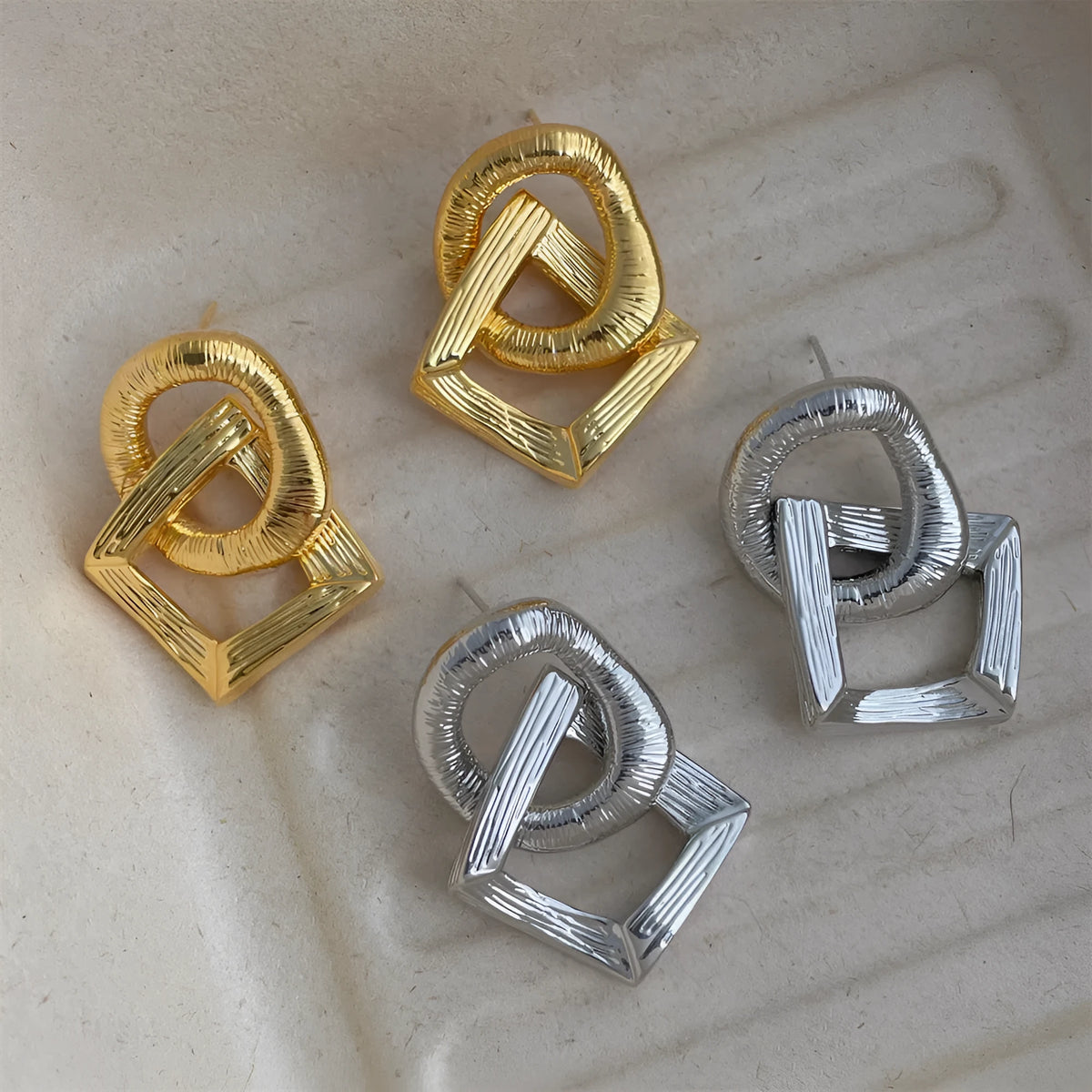 Retro-style geometric circle pendant drop earrings in gold or silver colour with a 3.4cm length.