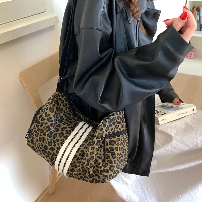 Leopard print sports style shoulder messenger bag with stitching detail and cross-body strap