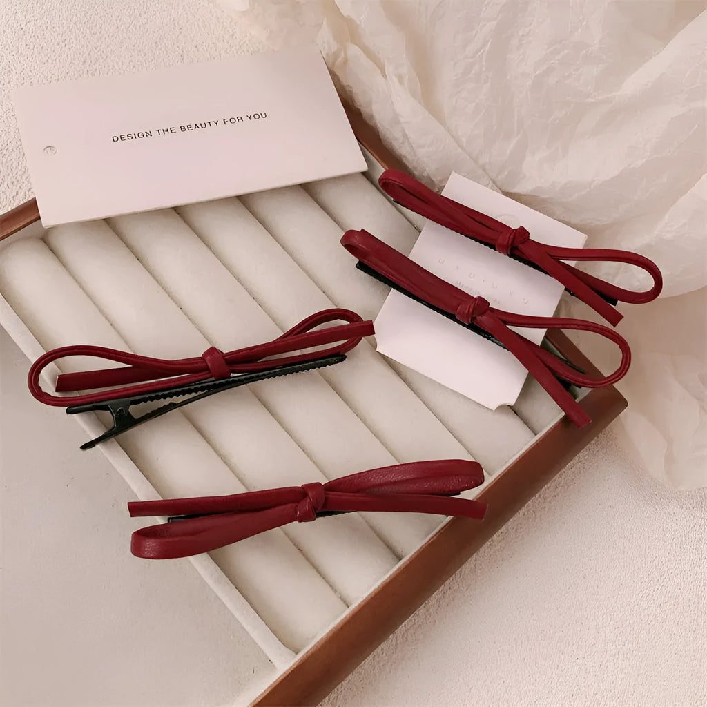 Wine red leather bow hair barrette showing manual craftsmanship and bow design details