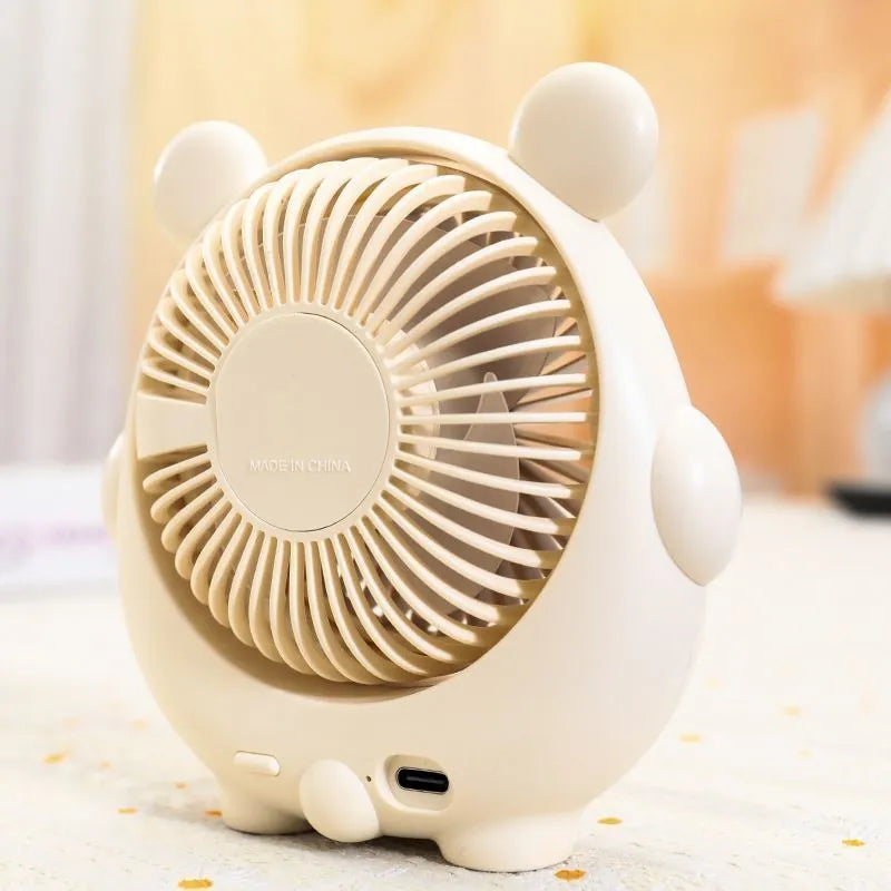 Cute dog-themed USB desktop electric fan in one of six available colours on a desk.
