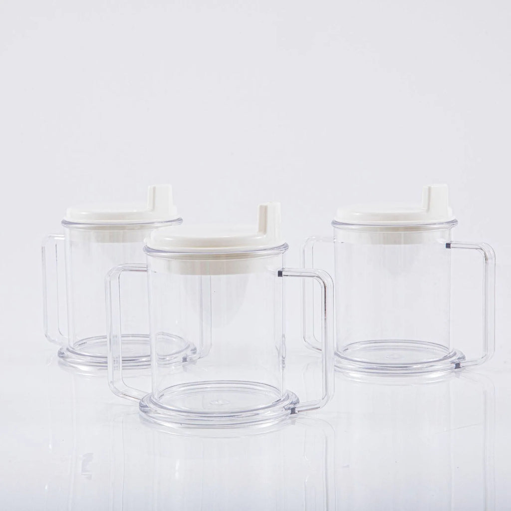 Transparent spill-proof plastic drinking cup on a table.