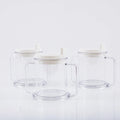 Transparent spill-proof plastic drinking cup on a table.