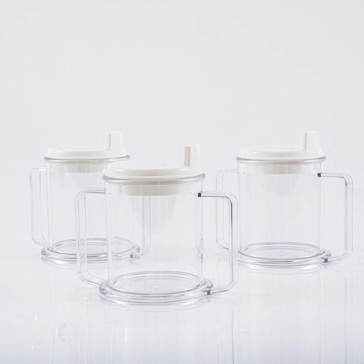 Transparent spill-proof plastic drinking cup on a table.