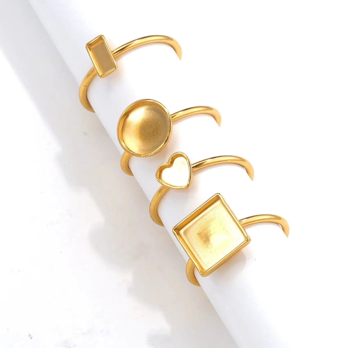 Golden stainless steel ring setting with various bezel shapes for gemstones on ring holder