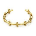 C-shaped stainless steel alloy bracelet with textured rivet-shaped beads on a wrist.