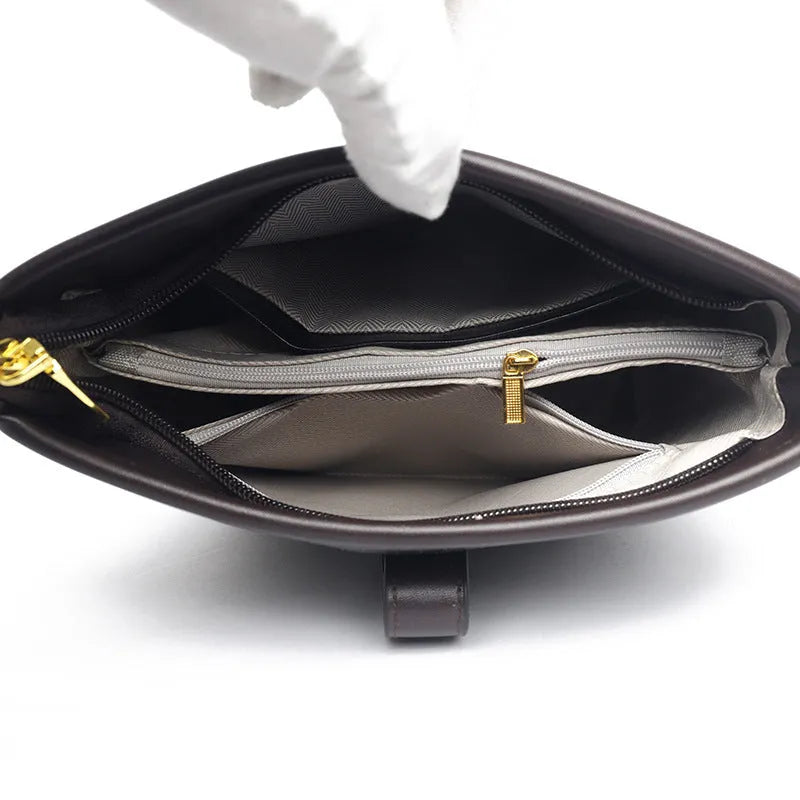 Korean style black bucket messenger bag with double shoulder strap showing zip compartments and urban design details