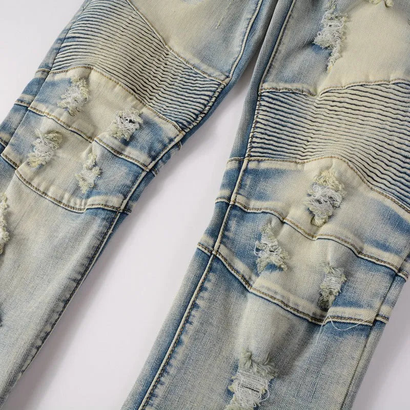 Light blue men's slim fit distressed jeans with hand-frayed details on a mid waist, showing a light straight leg cut.