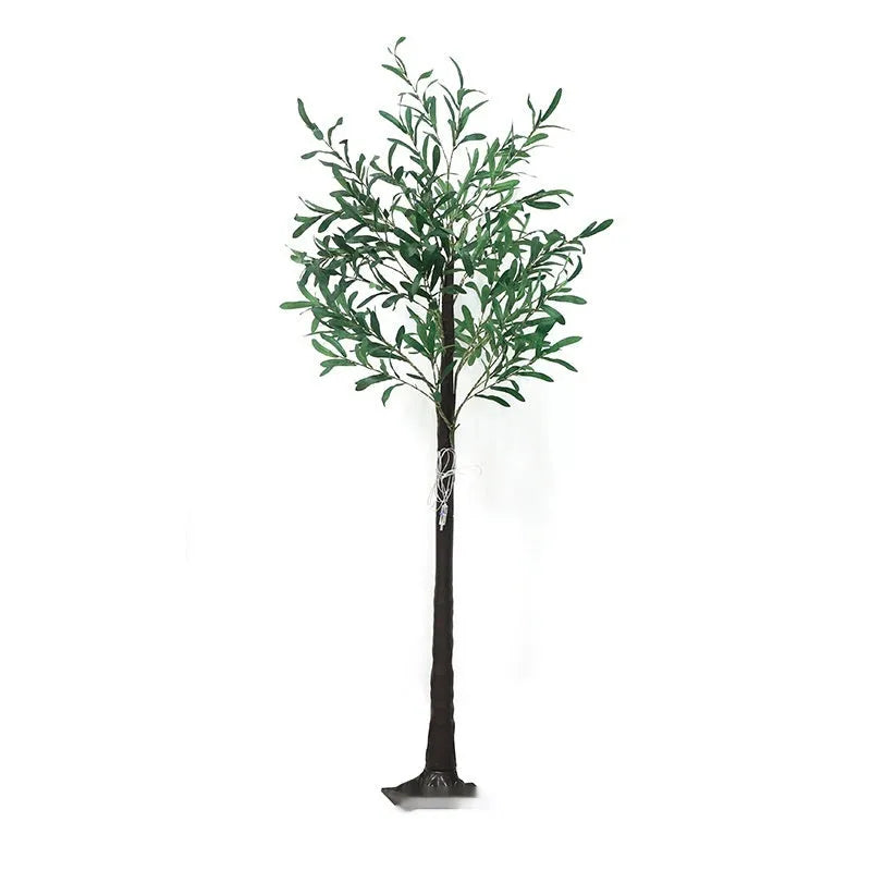 Tall artificial olive tree lamp with warm white LED lights illuminated in an outdoor courtyard setting.