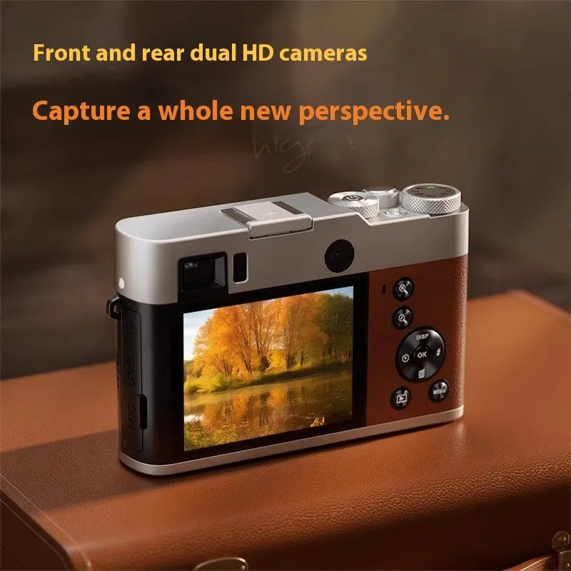 Black and brown 5K digital camera with dual lenses, optical viewfinder, and 2.88-inch screen on a table with accessories.