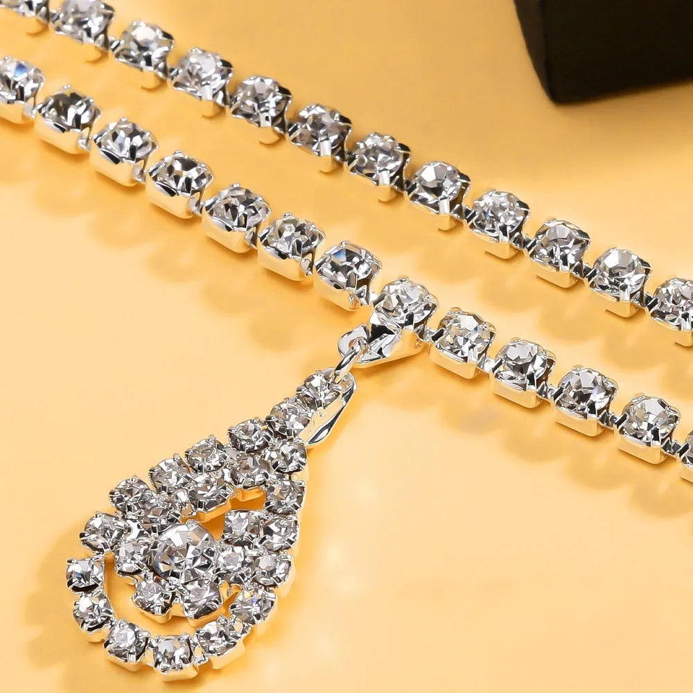 Gold waist chain with water drop pendant and rhinestone tassel measuring 115cm
