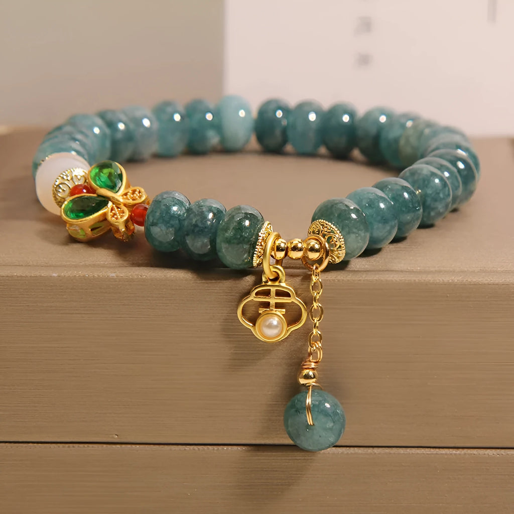 Blue water jade abacus bead crystal bracelet with butterfly charm and white agate beads