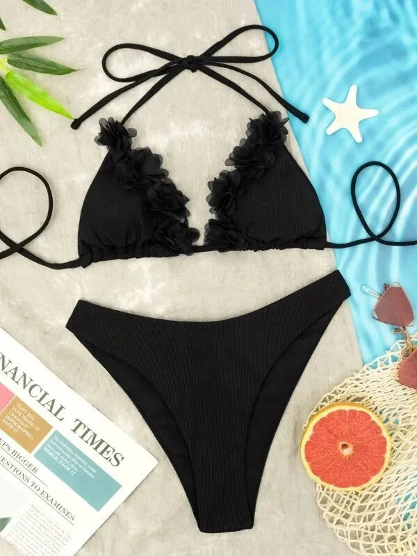 Black women's two-piece swimsuit set with a gathered design top and matching shorts on a neutral background.