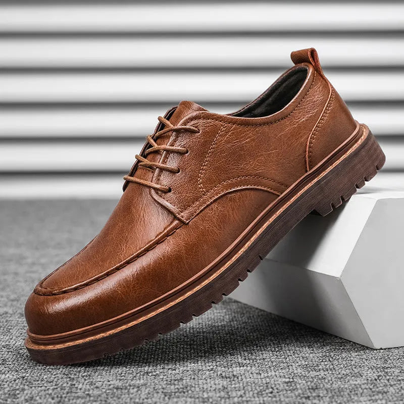Black and brown round-toe casual leather shoes with visible stitching and flat rubber soles.