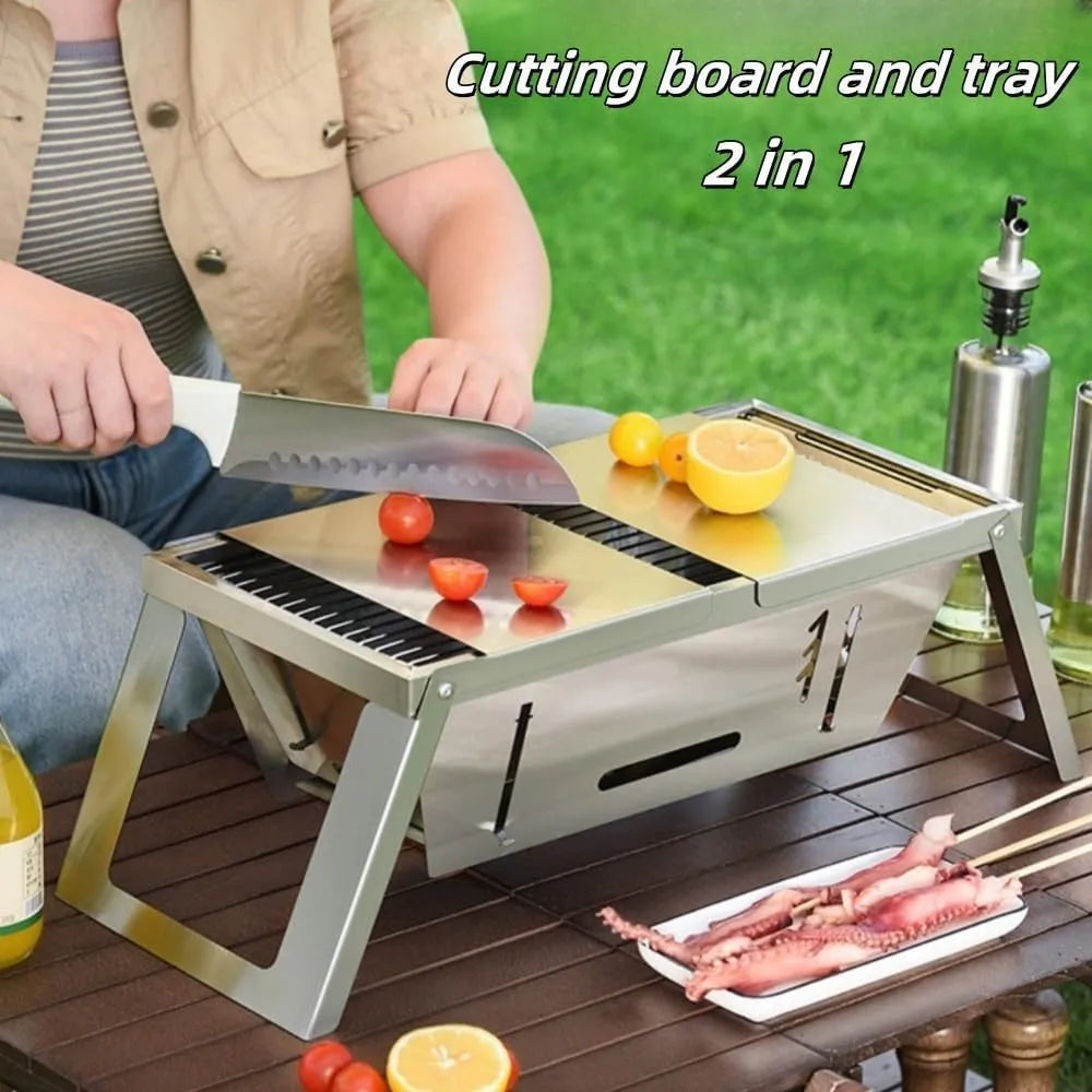 Small folding portable charcoal grill shown set up for an outdoor barbecue.