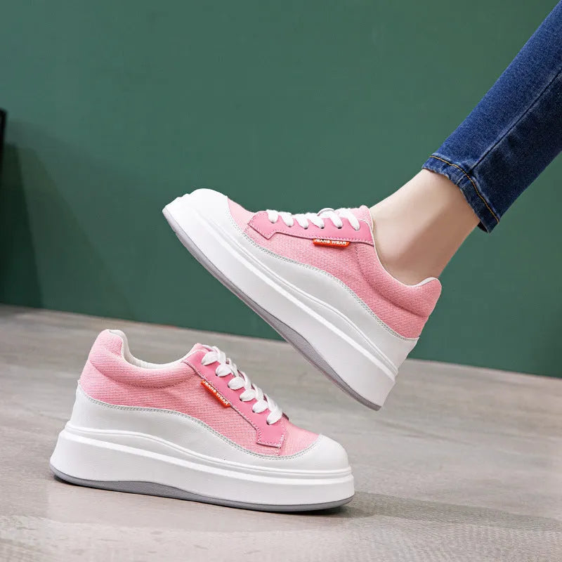 Women's pink leather board shoes with thick flat soles on a neutral background.
