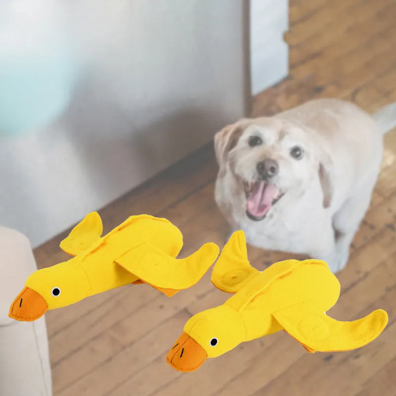 Yellow plush duck dog toy with squeaker and food leak compartment for treats.