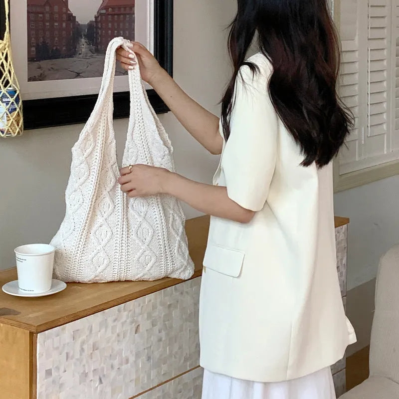 Retro hollow-knitted women's shoulder tote bag in a solid colour, showing double straps and textured fabric.