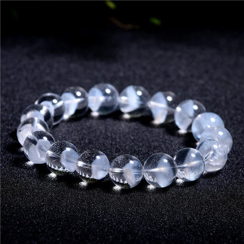 Women's natural white crystal ghost pyramid bracelet with Ruyi design on a model's wrist