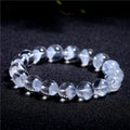Women's natural white crystal ghost pyramid bracelet with Ruyi design on a model's wrist
