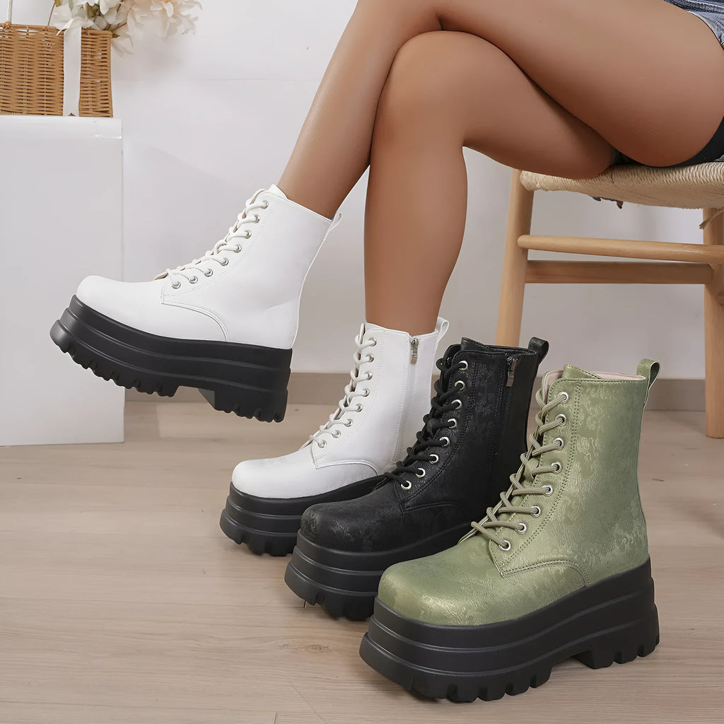 Women's black platform Martin boots with patchwork design, chunky heel, and side zipper.
