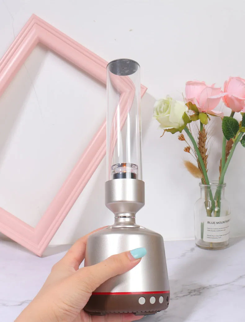 White silver Bluetooth speaker with candlelight night light showing push button controls and modern simple design