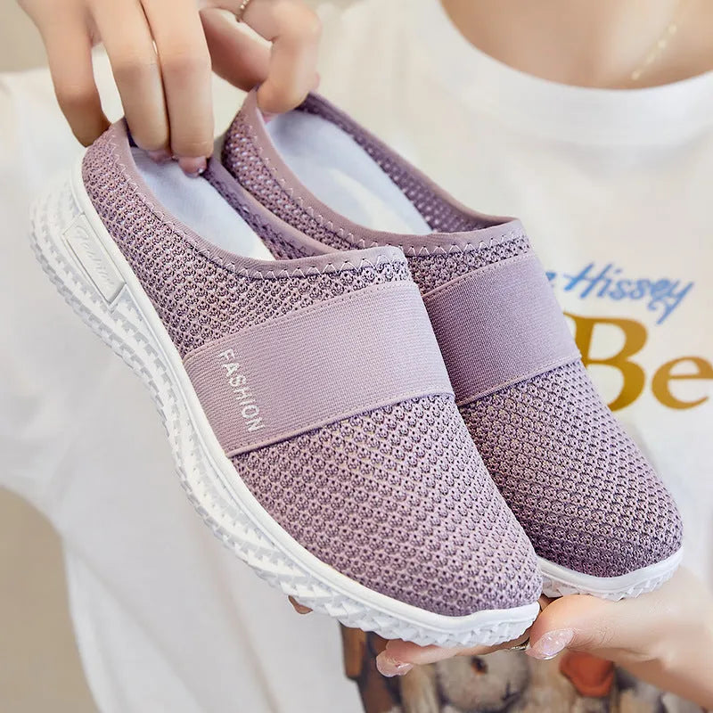 Women's black mesh casual flat shoes with hollow-out design and round toe on a flat heel.
