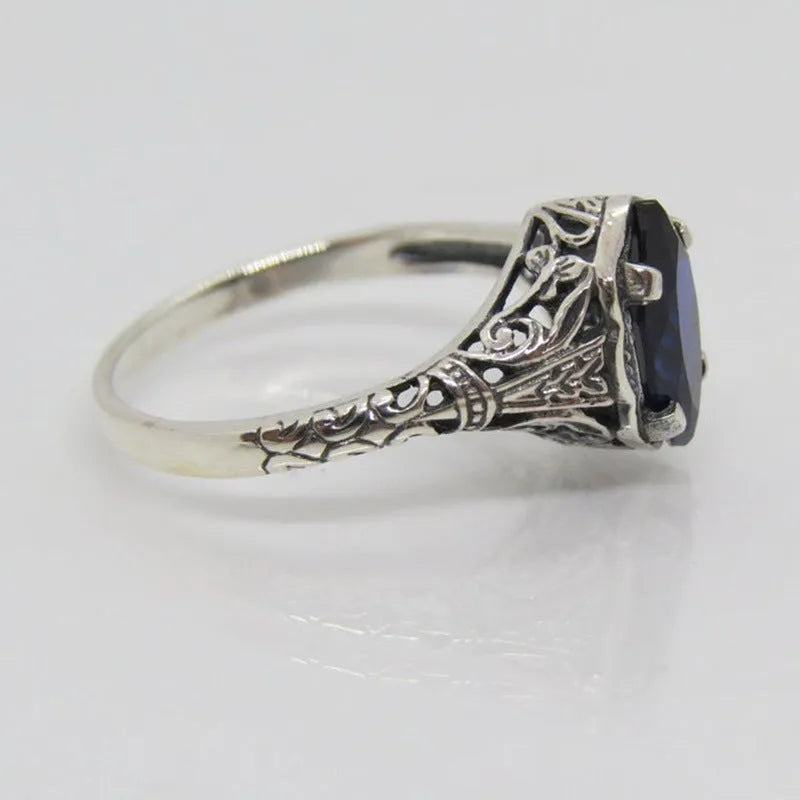 Women's silver geometric hollow ring with zircon stone on alloy band.