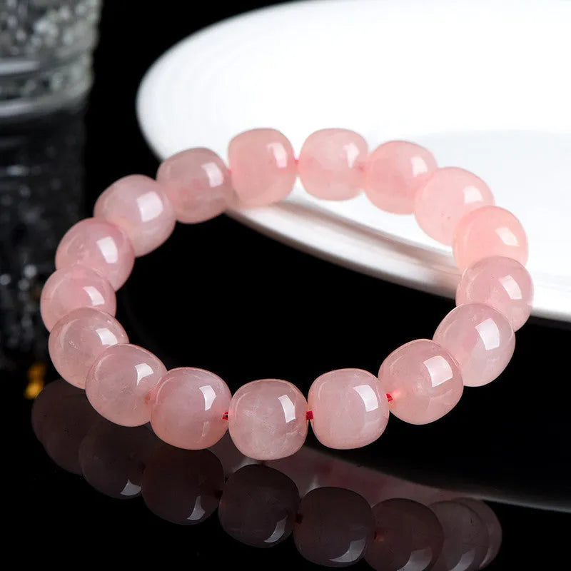 Pink natural crystal barrel bead bracelet with polished 8-10mm gemstone beads on wrist