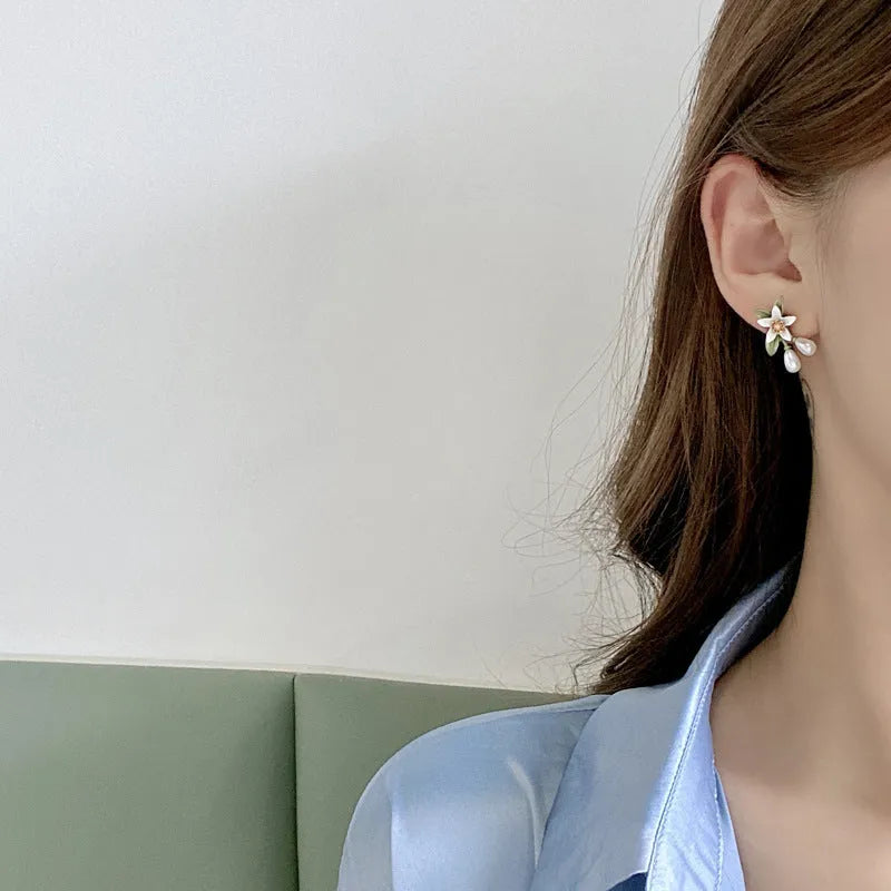 Alloy flower earrings for women, showing stud and clip styles with contrasting colour floral design.